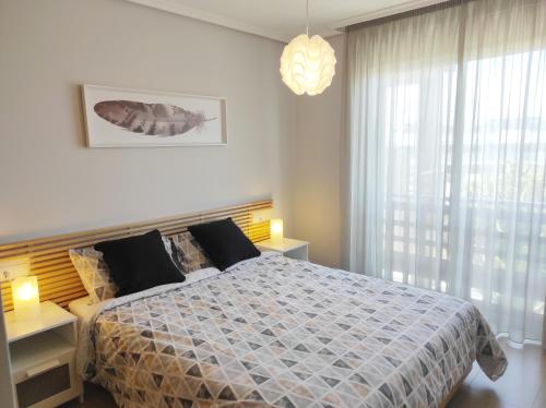 a bedroom with a bed and a large window at Tejita Playa in Granadilla de Abona