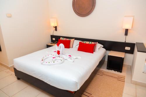 a bedroom with a bed with a stuffed animal on it at Vincci Dar Midoun in Djerba