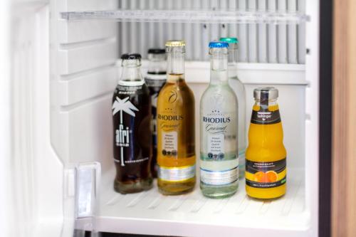 a refrigerator filled with lots of bottles of alcohol at Diehls Hotel in Koblenz