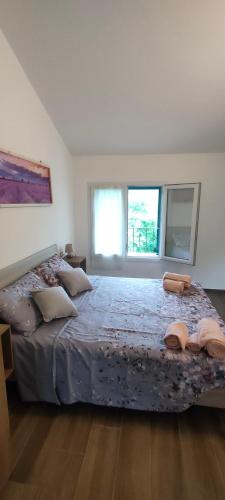 a large bed in a bedroom with two windows at Agriturismo Ca' du Nibile di Bove Gabriele in Carbuta