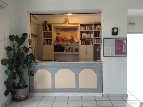 a library with a blue counter in a room at King Thiras Hotel in Fira