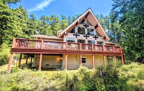 a house with a large deck on the side of it at Villa w/ Amazing Bay Views Near Beach w/ Garden, Ping Pong in Eastsound