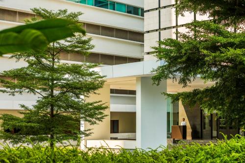 a person standing in the doorway of a building at COMO Metropolitan Bangkok in Bangkok