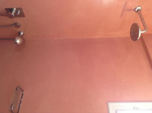 a wall with a spatula and a cross on it at King Thiras Hotel in Fira