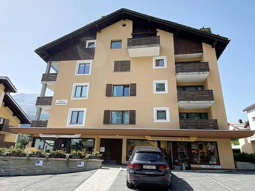a building with a car parked in front of it at Ski & Kite, zentral, modern, 80m2, Balkon - MU11 in Silvaplana