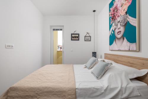 a bedroom with a bed with two pillows on it at Apartments Vila Belvedere in Rijeka