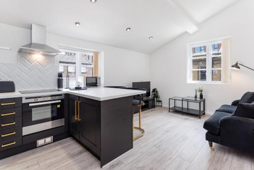 an open kitchen and living room with a couch at Air Host and Stay - Beautiful modern Rodney Street apartment in Liverpool
