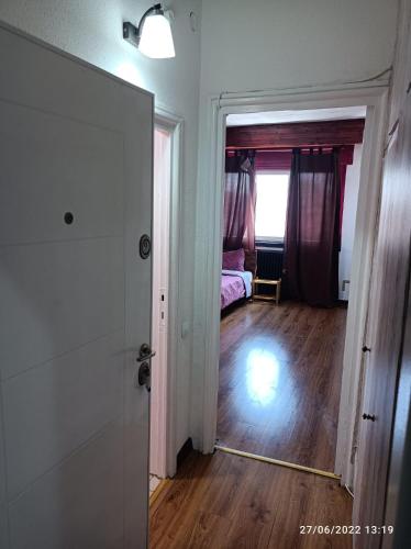 a room with a door leading to a bedroom with a bed at Sweet central apartment in Bucharest