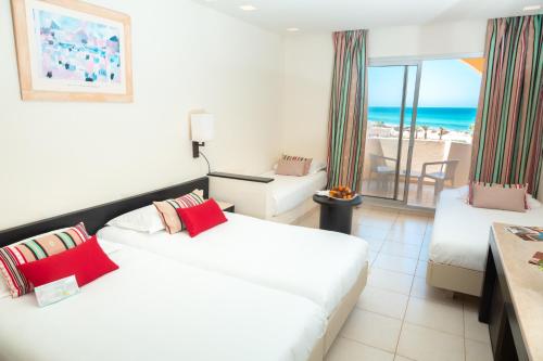 a hotel room with two beds and a view of the ocean at Vincci Dar Midoun in Djerba