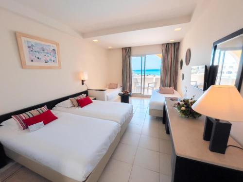 a hotel room with two beds and a view of the ocean at Vincci Dar Midoun in Djerba