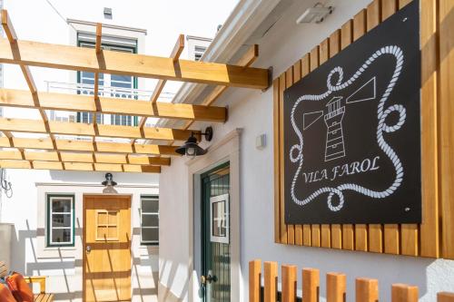 a sign for a restaurant on the side of a building at Vila Farol in Nazaré