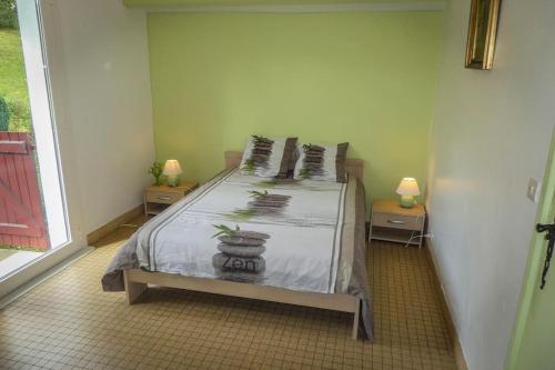 a bedroom with a bed and two tables with lamps at Gite individuel au pays BASQUE à 1,5km de ST-Jean-Pied-de-port in Saint-Jean-Pied-de-Port