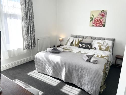 a bedroom with a bed with two stuffed animals on it at Entire holiday home in Blackpool with free parking and a private patio garden in Blackpool