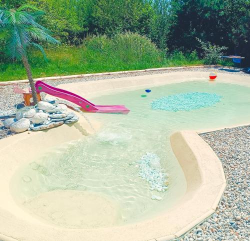 a pool with a water slide in a swimming pool at Chalet d' amour in Kamenný Újezd