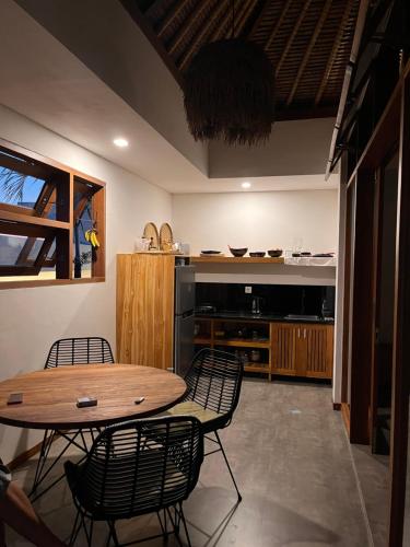 a kitchen with a table and chairs in a room at La Reserva Villas Bali in Jimbaran