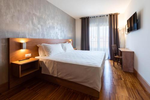 Säng eller sängar i ett rum på Torre Antica Venice Airport Hotel