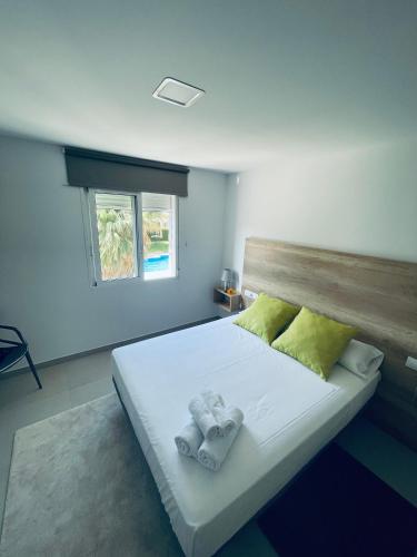 a bedroom with a bed with towels on it at Villamartin Hotel GHB in Orihuela Costa