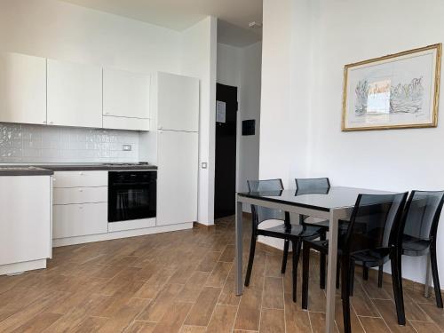 a kitchen and dining room with a table and chairs at Nuraghe Apartments in Teulada
