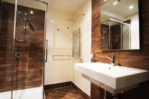 a bathroom with a sink and a shower at Nuraghe Apartments in Teulada