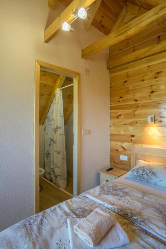 a bedroom with a bed and a large mirror at Apartments Stevovic in Žabljak