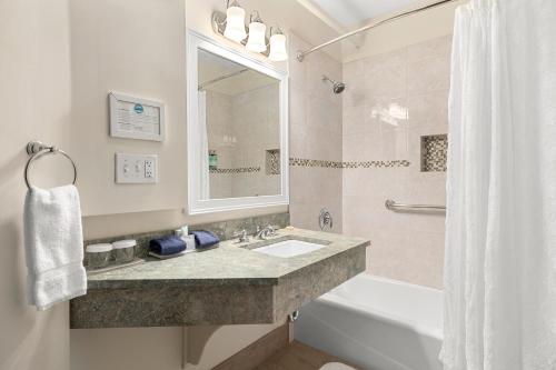 a bathroom with a sink and a tub and a shower at Black Point Inn in Scarborough