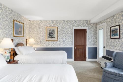 a hotel room with two beds and a chair at Black Point Inn in Scarborough