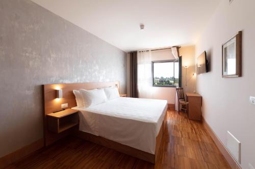 a hotel room with a bed and a window at Torre Antica Venice Airport Hotel in Tessera