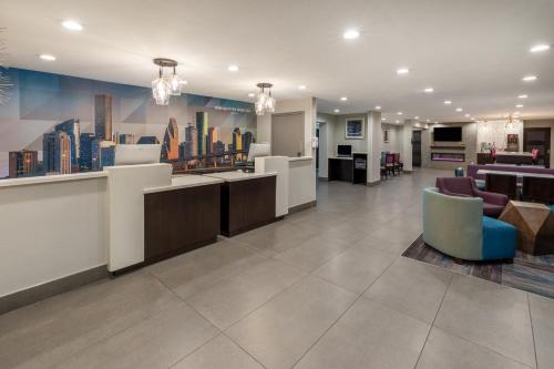 a lobby with a city mural on the wall at La Quinta by Wyndham Houston NW Brookhollow in Houston