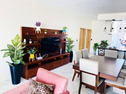 a living room with a table and a dining room at HERMOSO DEPARTAMENTO A UNOS PASOS DE LA PLAYA in Mazatlán