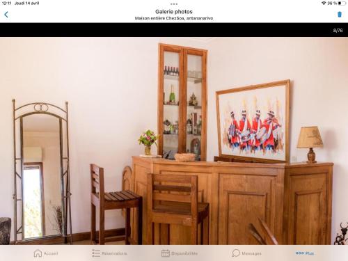 a room with a mirror and a wooden dresser at Maison entière ChezSoa, antananarivo in Andoharanofotsy