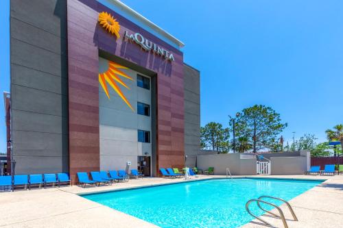 a hotel swimming pool in front of a building at La Quinta by Wyndham Houston NW Brookhollow in Houston