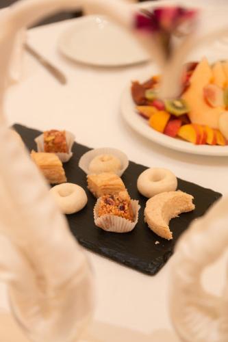 a plate of food on a table with snacks at Vincci Dar Midoun in Djerba