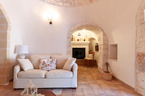 a living room with a couch and a fireplace at Le Dimore Di Speziale in Fasano