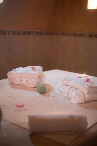 two folded towels sitting on top of a table at Vincci Dar Midoun in Djerba