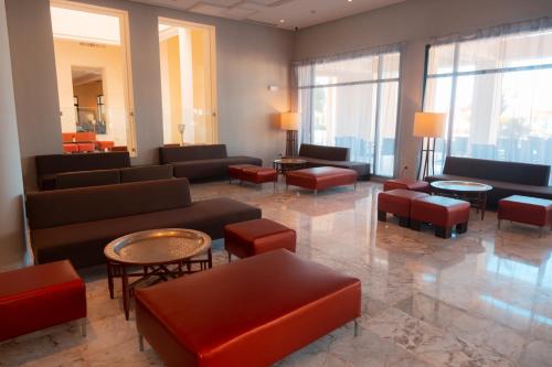 a large lobby with couches and tables and windows at Vincci Dar Midoun in Djerba