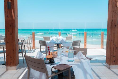 a table set up for a meal on the beach at Vincci Dar Midoun in Djerba