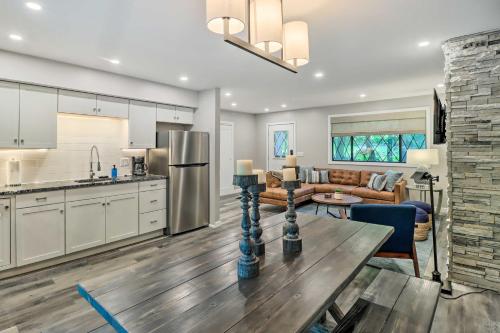 a kitchen and living room with a table and a couch at Near Skiing and Hiking Gouldsboro Home with Hot Tub in Gouldsboro