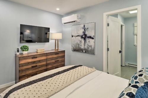 a bedroom with a bed and a flat screen tv at Near Skiing and Hiking Gouldsboro Home with Hot Tub in Gouldsboro