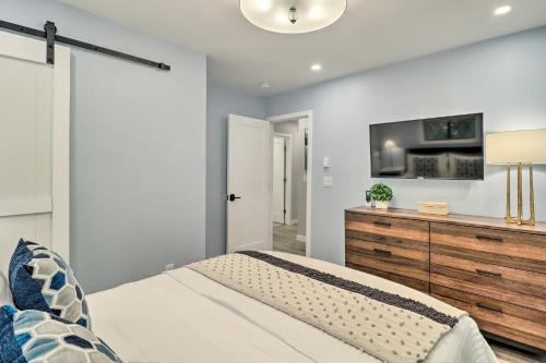 a bedroom with a bed and a tv on a wall at Near Skiing and Hiking Gouldsboro Home with Hot Tub in Gouldsboro