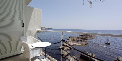 a balcony with a table and a view of the ocean at Giuggiulena in Siracusa