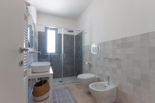 a bathroom with a toilet and a sink and a shower at Le Dimore Di Speziale in Fasano