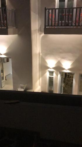 a view of a white building with a balcony at Theros Apartments Donoussa in Donoussa