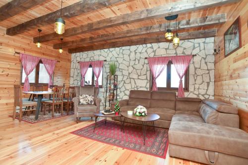 a living room with a couch and a table at Big bear villas in Žabljak