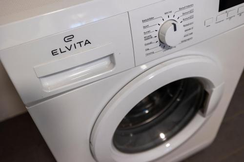 a white washing machine sitting in a room at Heidi Guesthouse in Selfoss