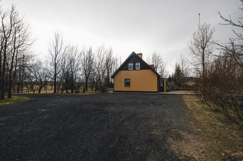a house sitting on the side of a road at Heidi Guesthouse in Selfoss