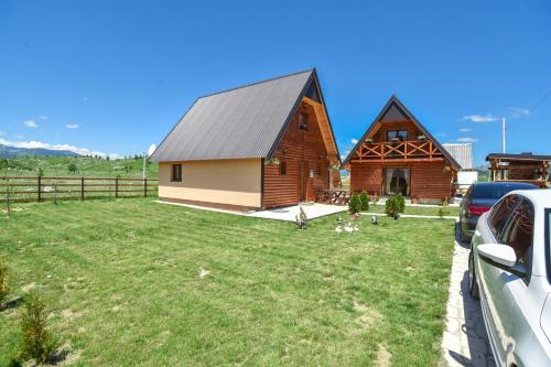 a home with a barn with a yard at Big bear villas in Žabljak