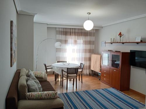 a living room with a couch and a dining room table at Fonte Zeta in Baiona