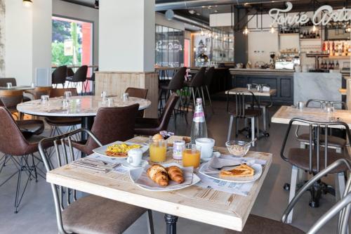 a table with breakfast foods on it in a restaurant at Torre Antica Venice Airport Hotel in Tessera