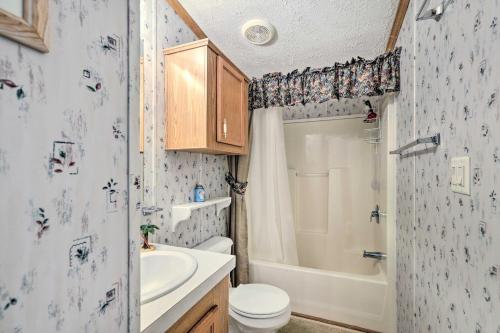 a bathroom with a toilet and a tub and a sink at Bright Steinhatchee Home Proximity to Ocean! in Steinhatchee