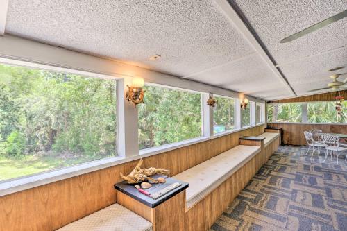 a room with windows and a bench in a house at Bright Steinhatchee Home Proximity to Ocean! in Steinhatchee